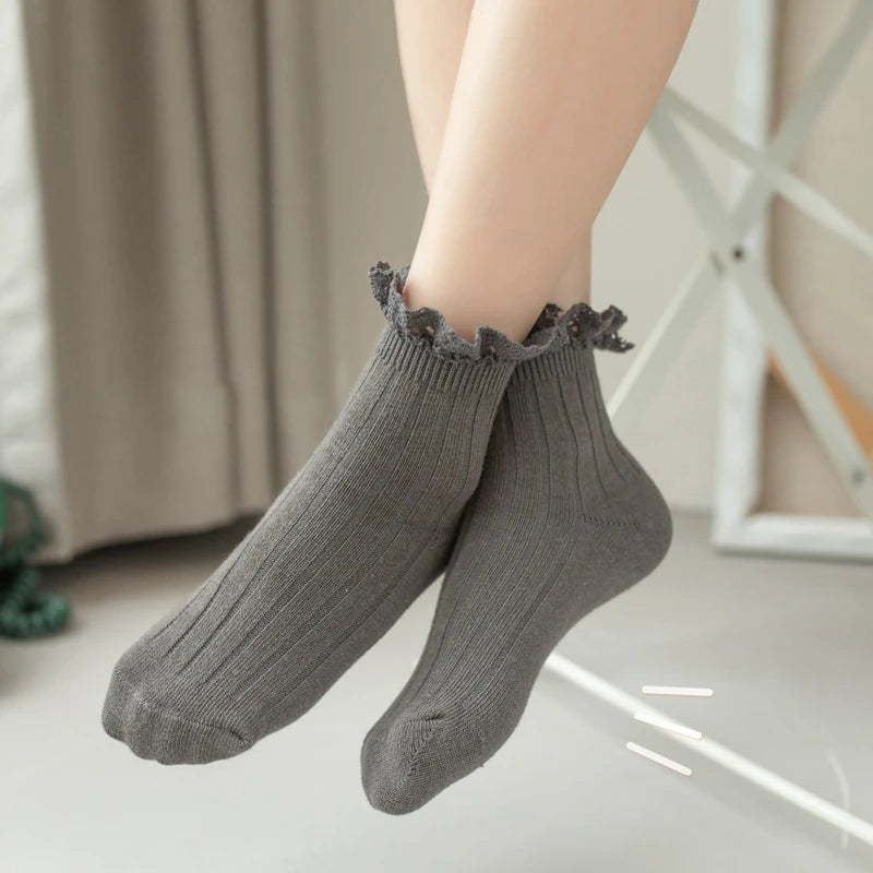 Child wearing grey ribbed frill socks