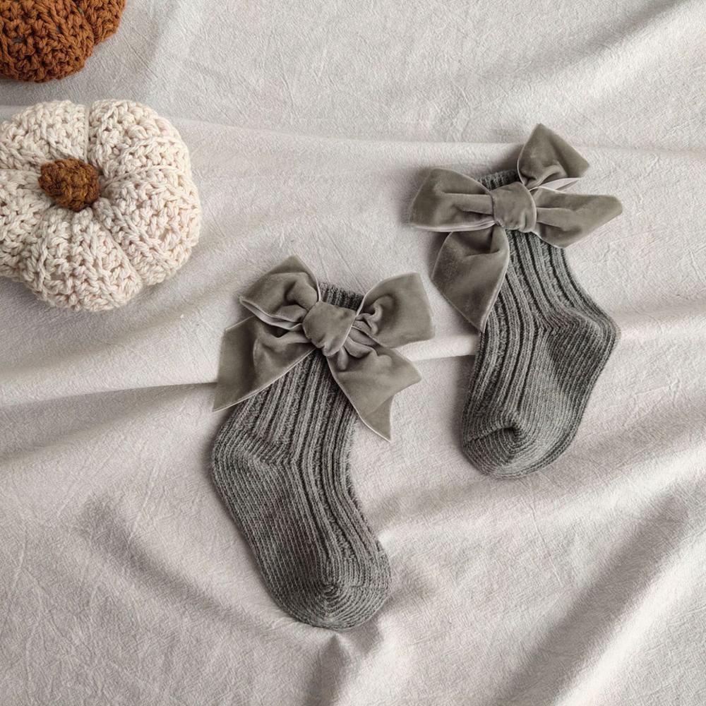 Grey ribbed knit baby socks with velvet bows