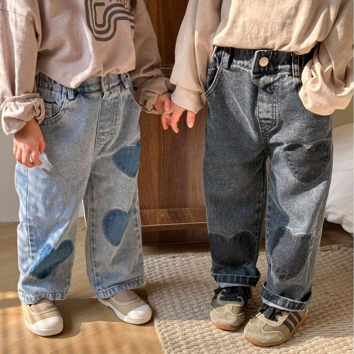 Pair of kids wearing heart patch straight leg jeans