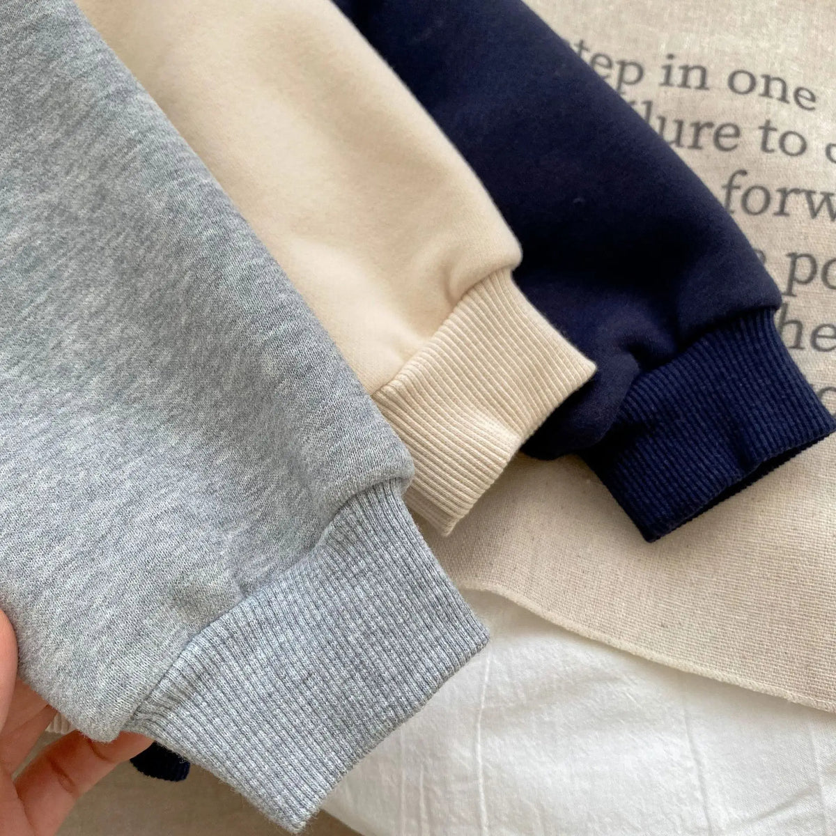 Close-up of ribbed cuffs on baby jackets