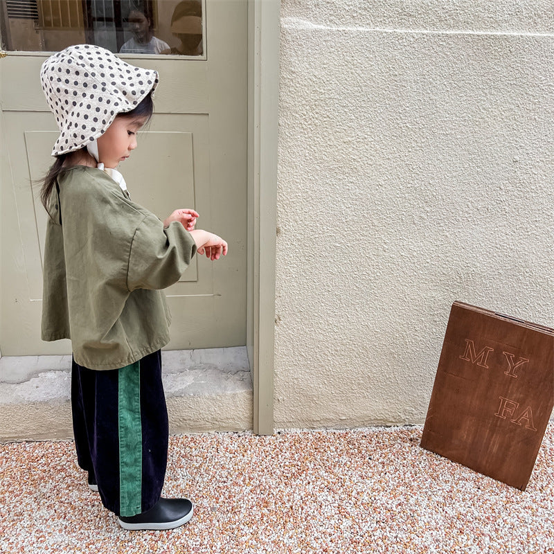 Child wearing navy corduroy pants and green sweater