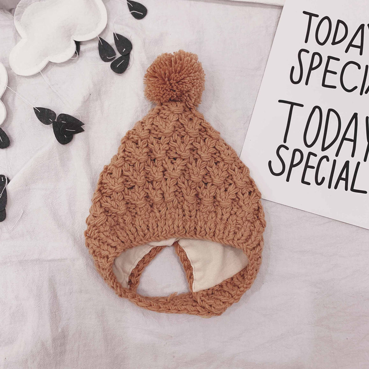 Orange chunky knit baby bonnet with pom-pom