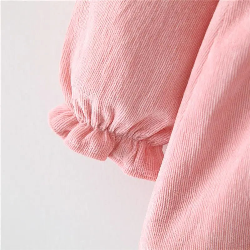 Close-up of gathered cuff on pink dress