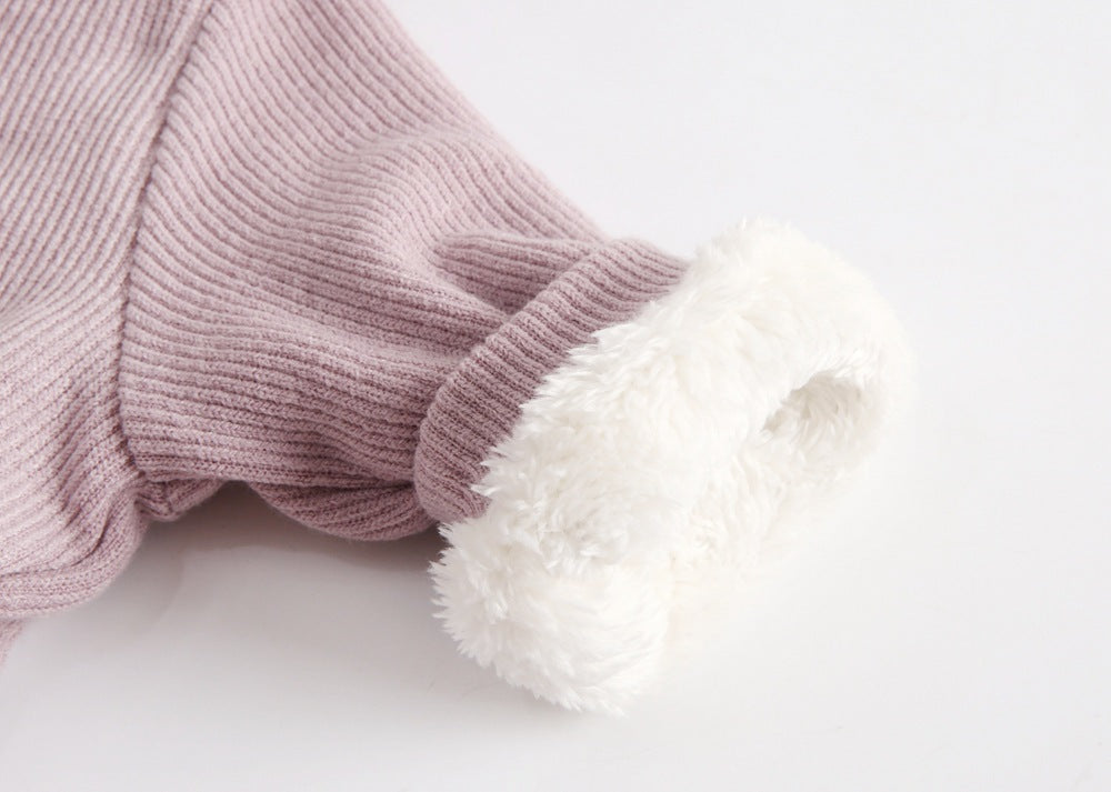 Close-up of sherpa-lined cuff on pink jumpsuit