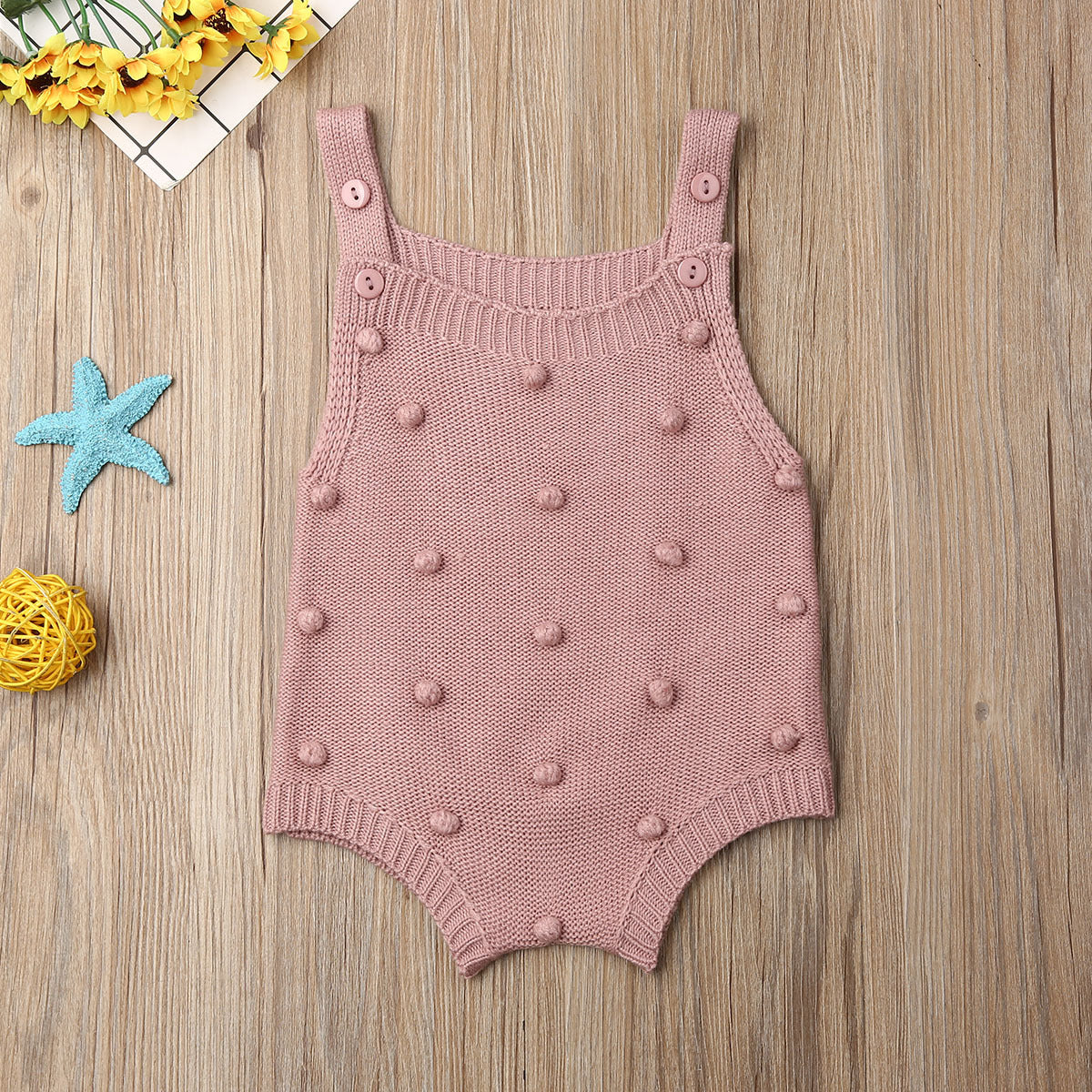 Pink sleeveless pom-pom knit baby romper
