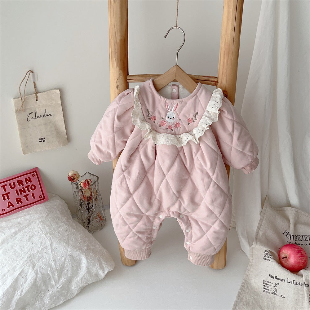 Pink quilted fleece-lined baby romper with ruffle collar on a hanger