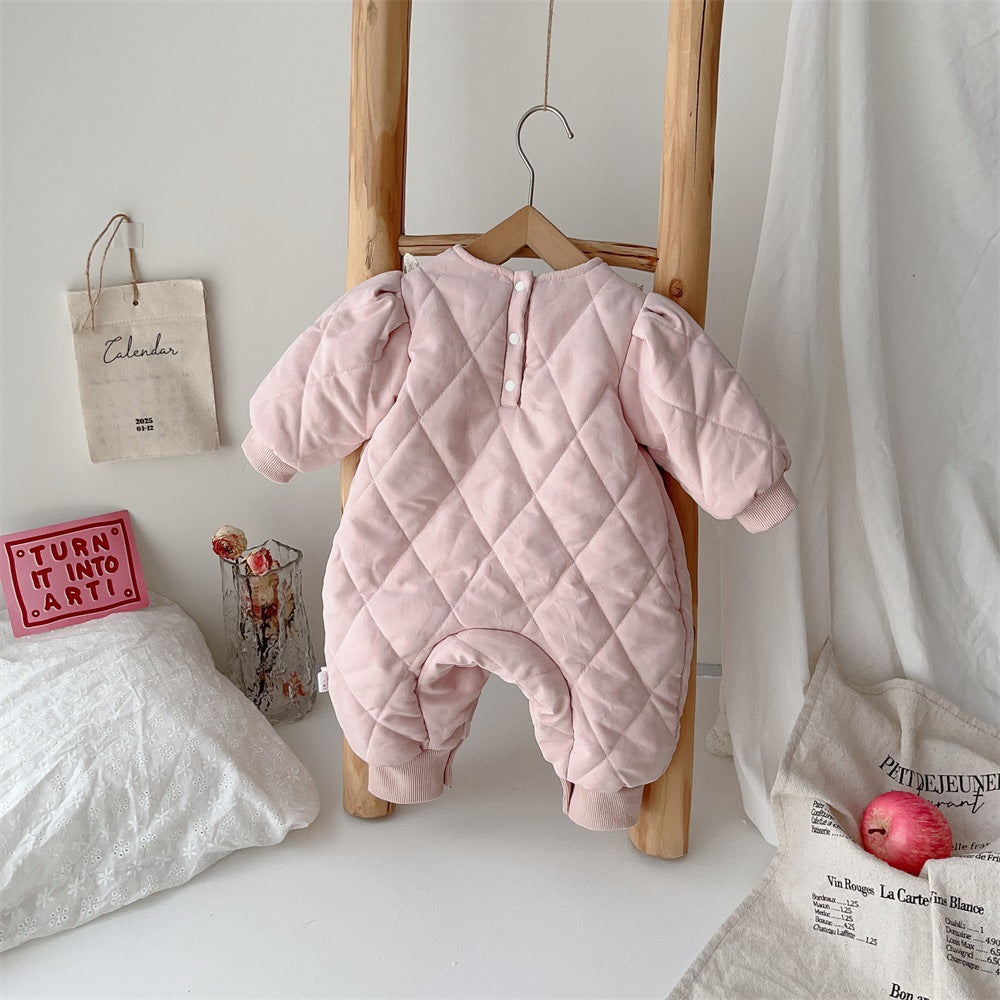 Back view of pink quilted baby romper on a hanger