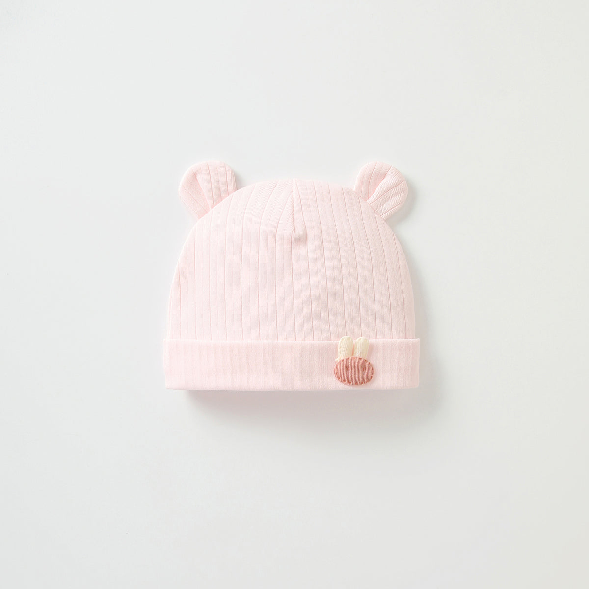 Pink ribbed baby beanie with ears and charm