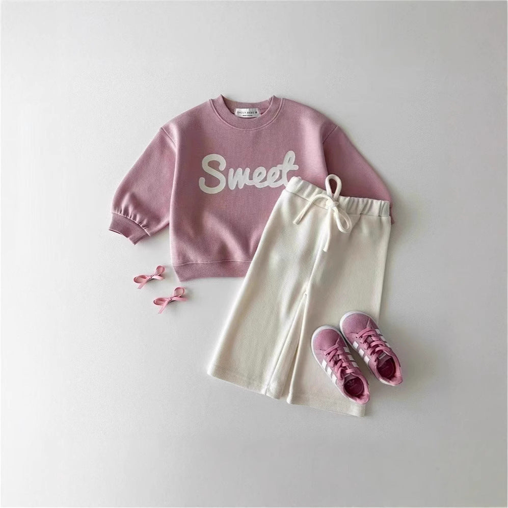 Pink Sweet letter sweatshirt styled with cream trousers and pink shoes