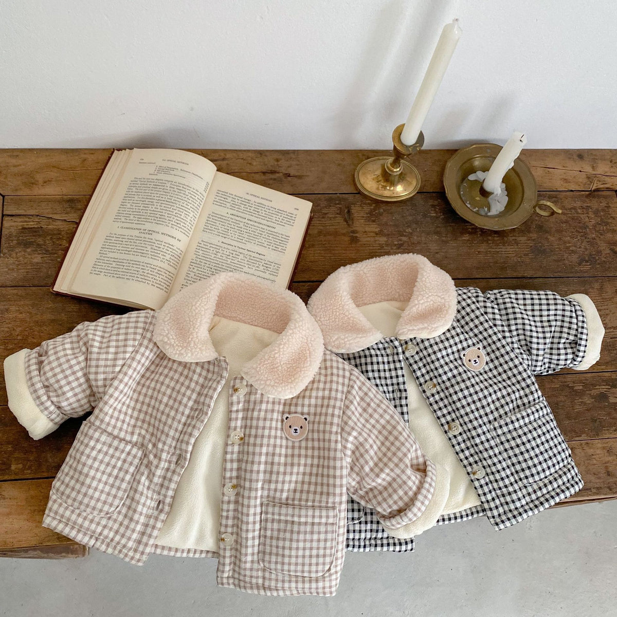 Brown and gray plaid bear jackets on a wooden table
