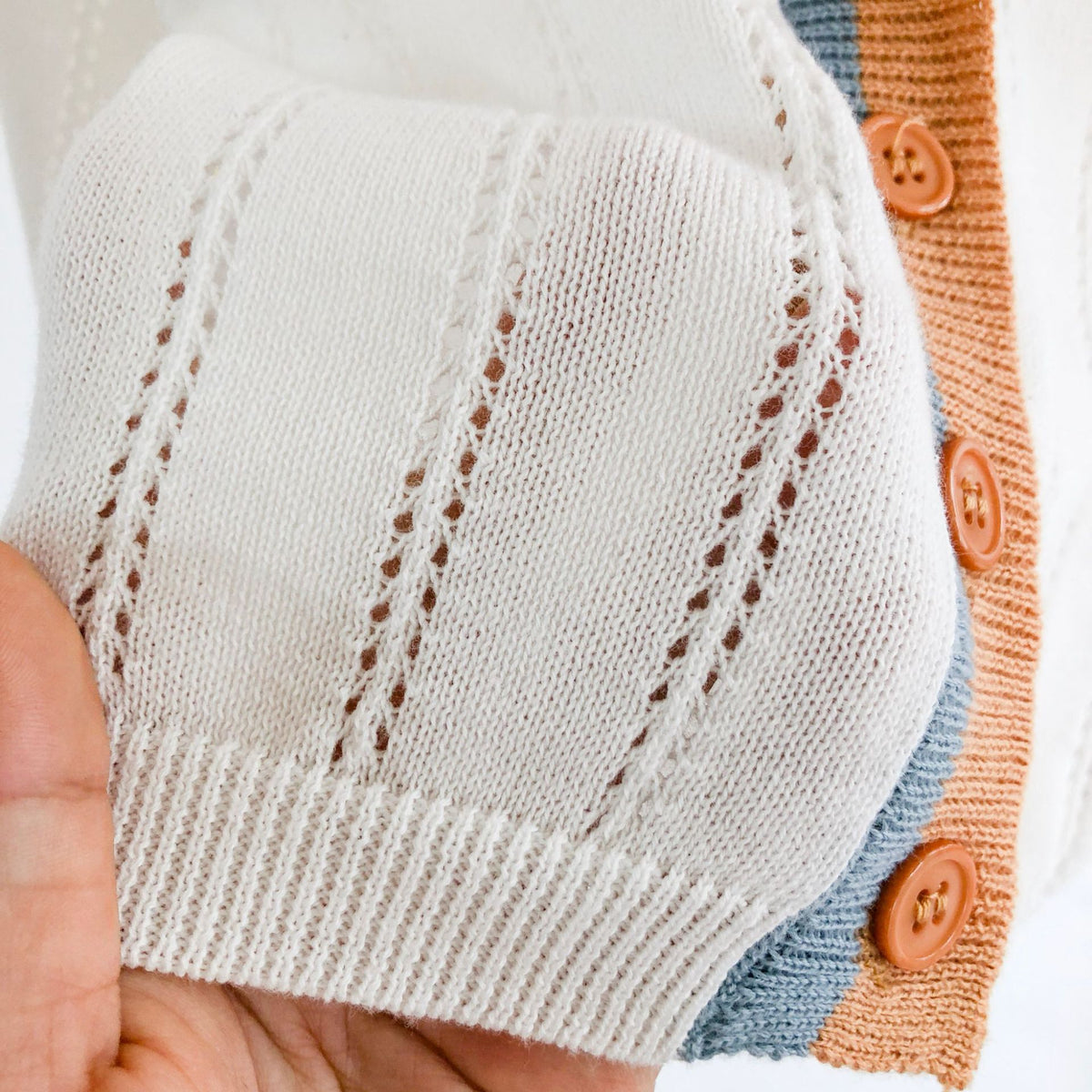 Close-up of pointelle knit pattern and buttons