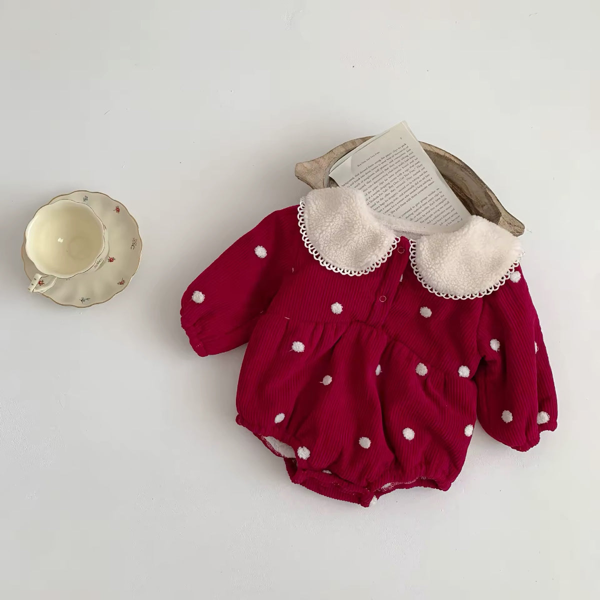 Red polka dot corduroy romper with lace trimmed collar and puff sleeves
