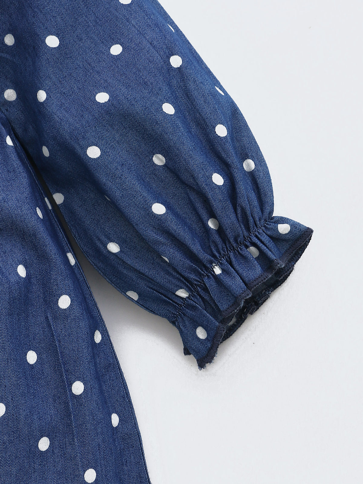 Close-up of elastic sleeve cuff on polka dot dress