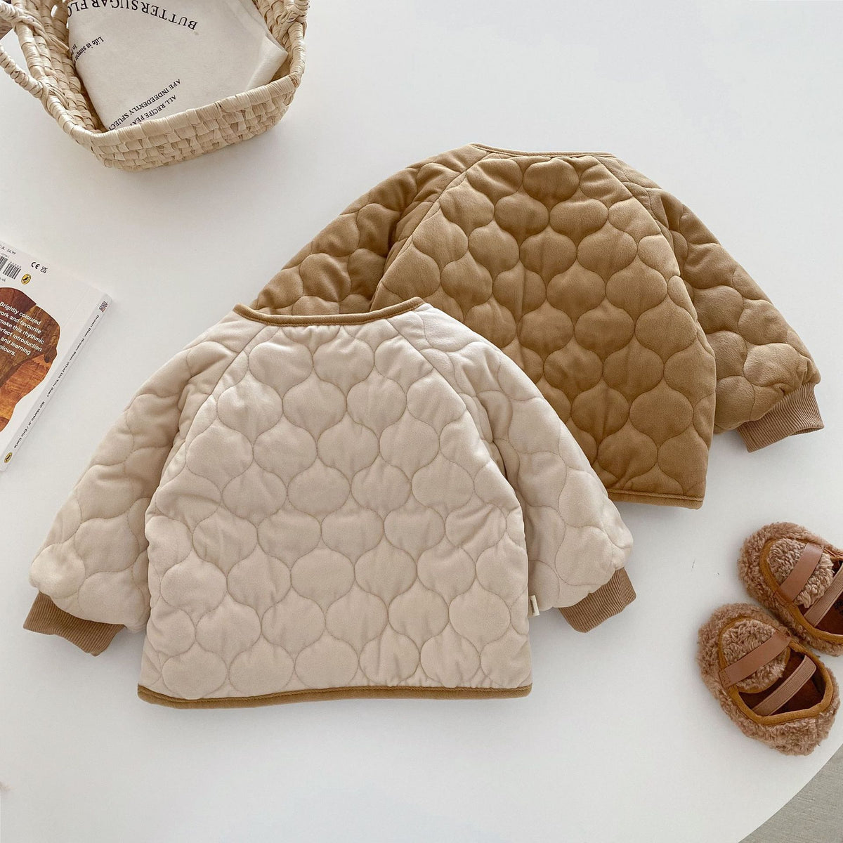 Back view of apricot and brown quilted baby jackets
