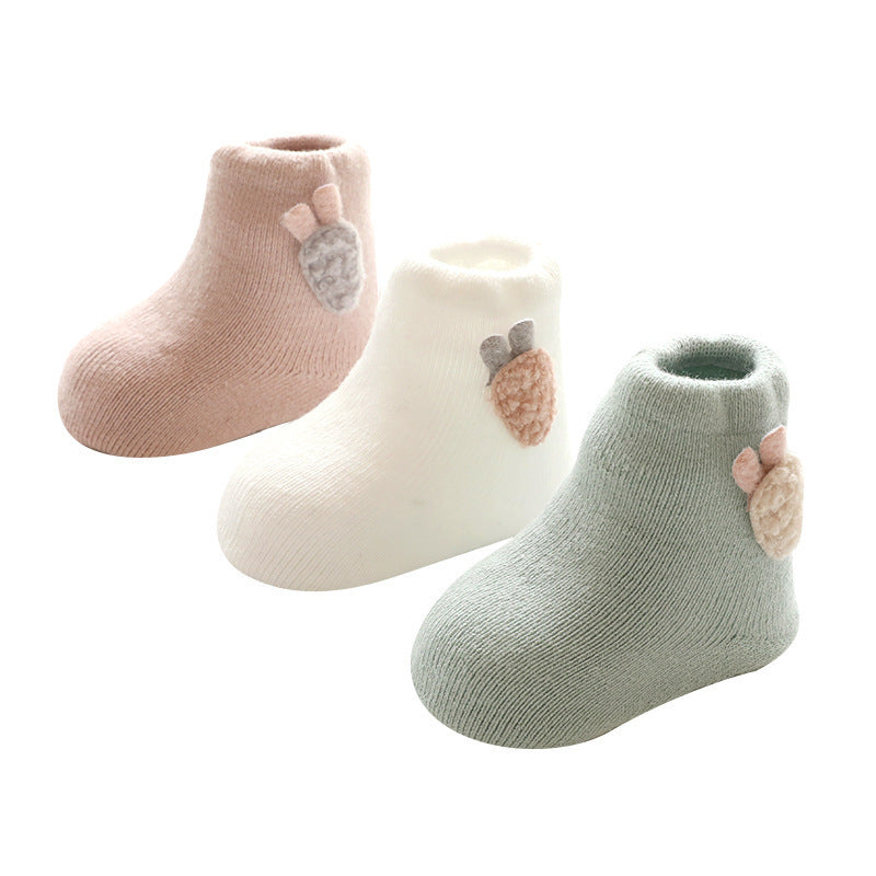 Pink, white and green baby socks with radish tags