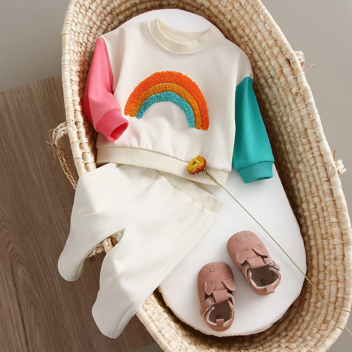 Rainbow colour block sweatshirt and pants in a basket