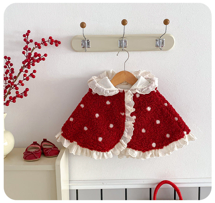 Red polka dot hooded baby cape with ruffle collar on a hanger
