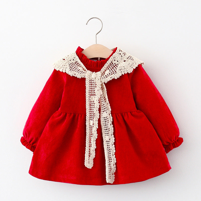 Red corduroy toddler dress with crochet lace tie collar on a hanger