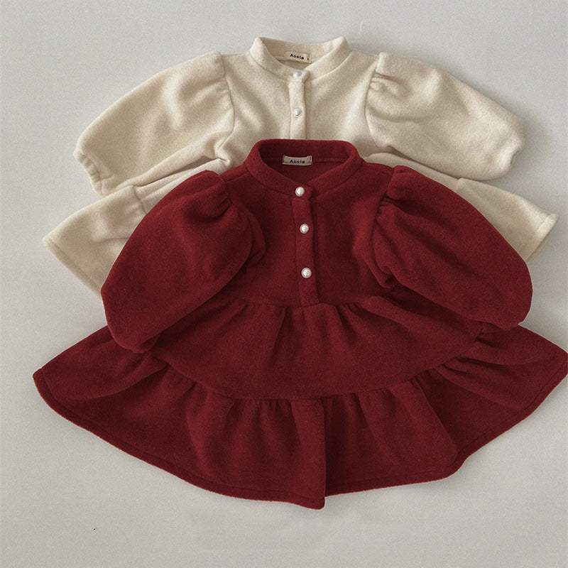 Red and cream fleece dresses with puff sleeves laid flat