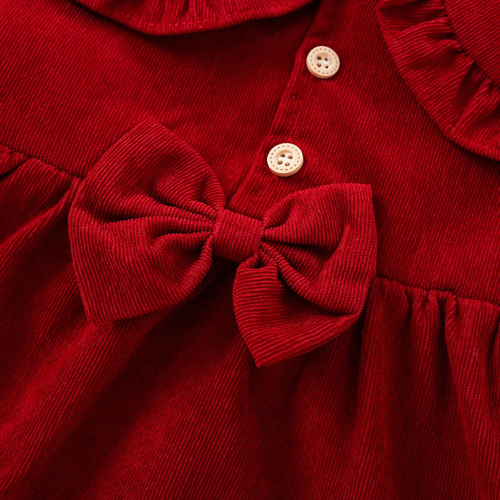 Close-up of bow and buttons on wine red dress