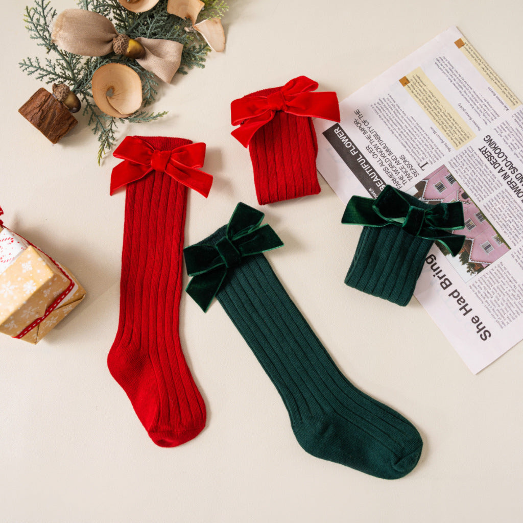 Red and green velvet bow toddler socks laid flat