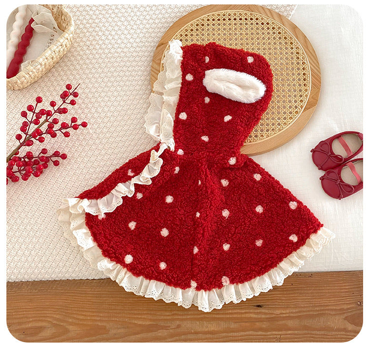 Red polka dot baby cape with cream ruffle trim laid flat