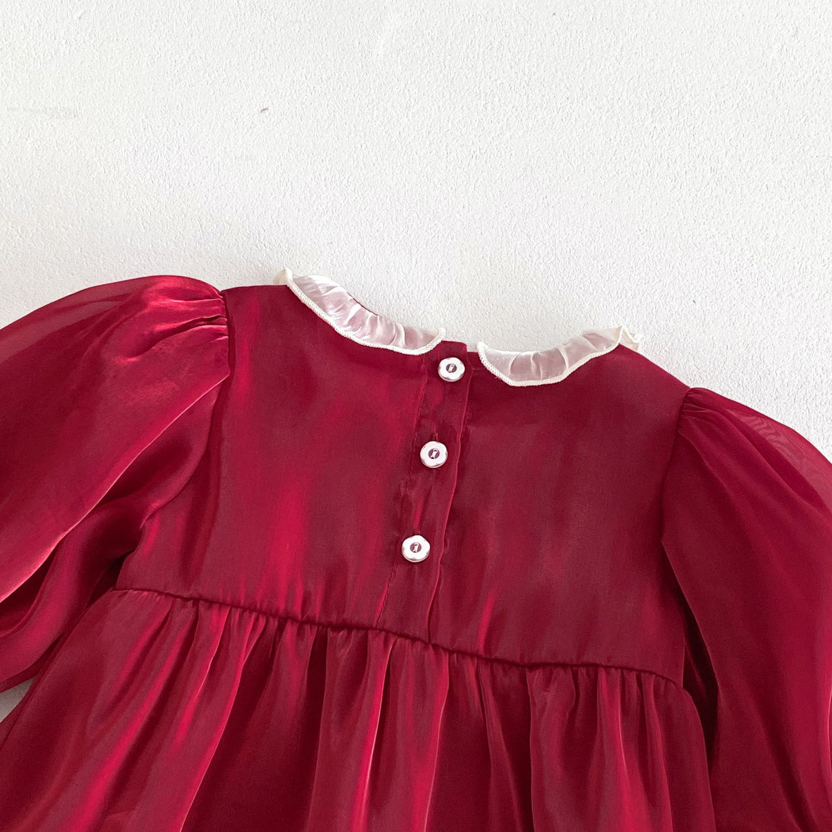 Close-up of back buttons and lace collar