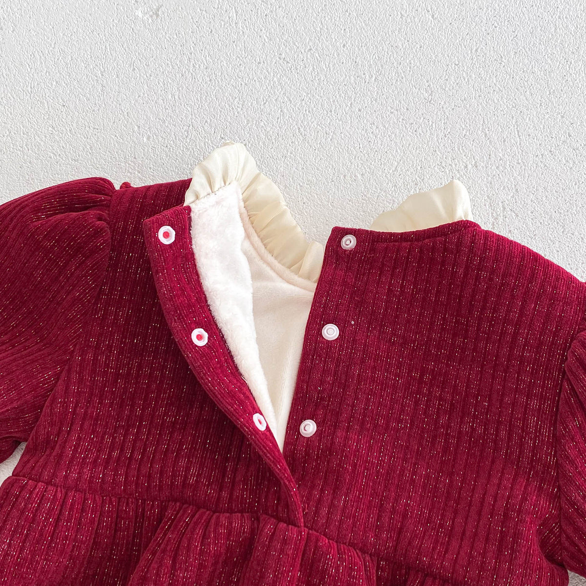 Close-up of back buttons and collar on red romper
