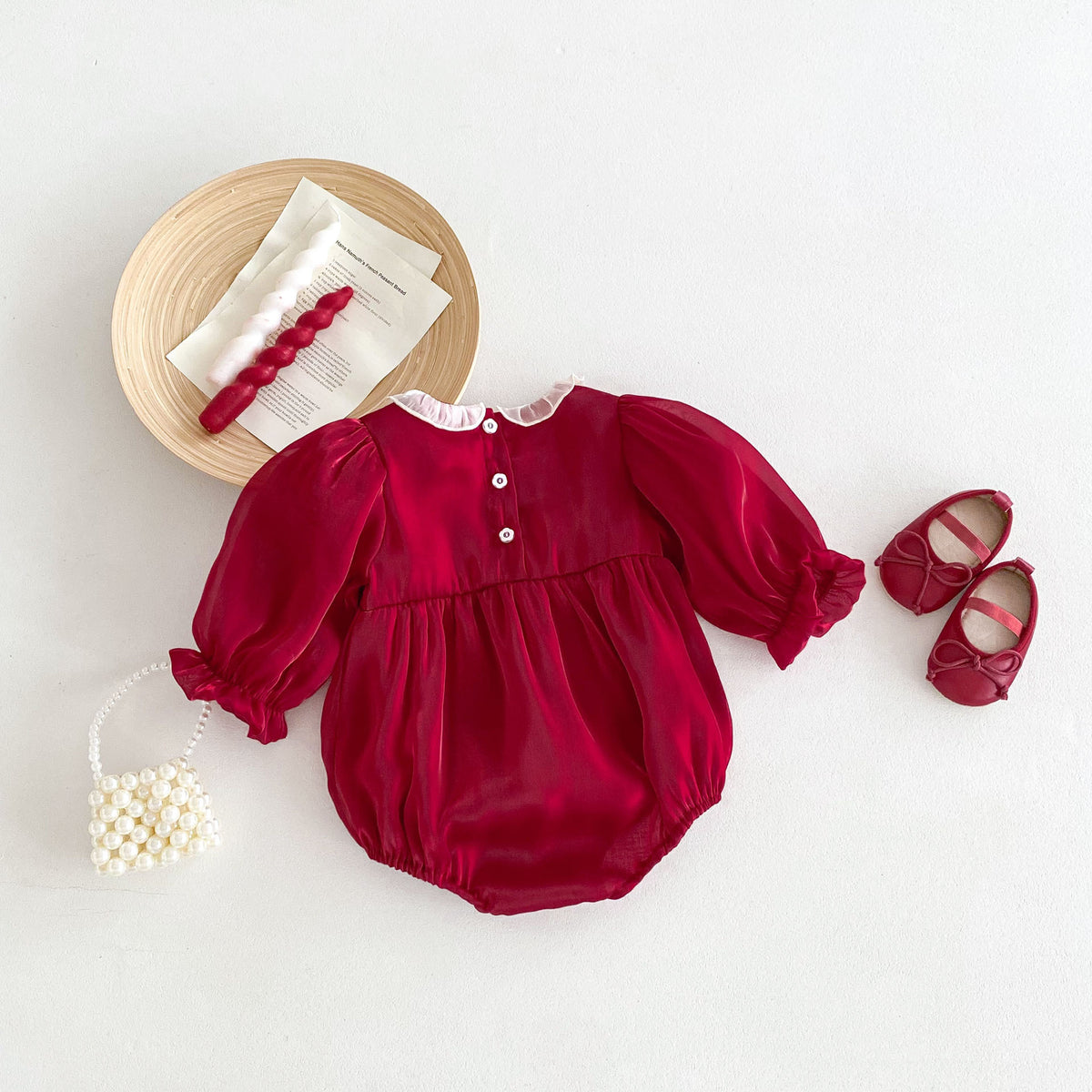Back view of red lace collar romper laid flat