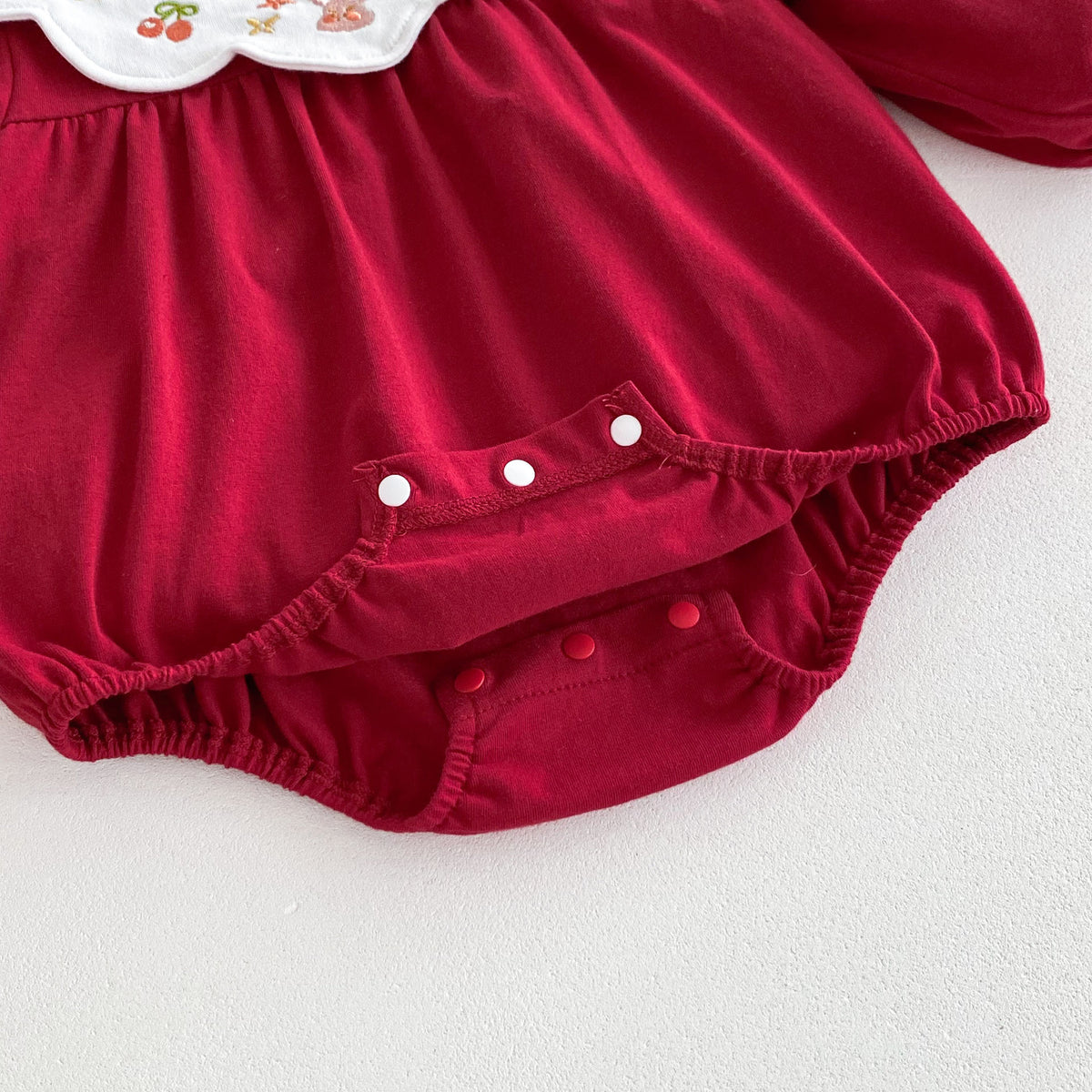 Snap crotch closure on red baby romper