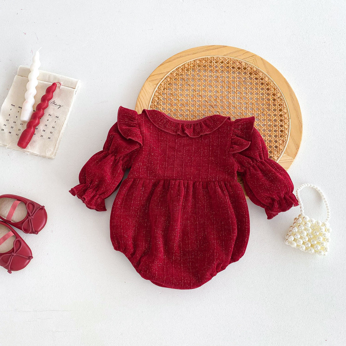 Red ruffle baby romper without bow, flat lay