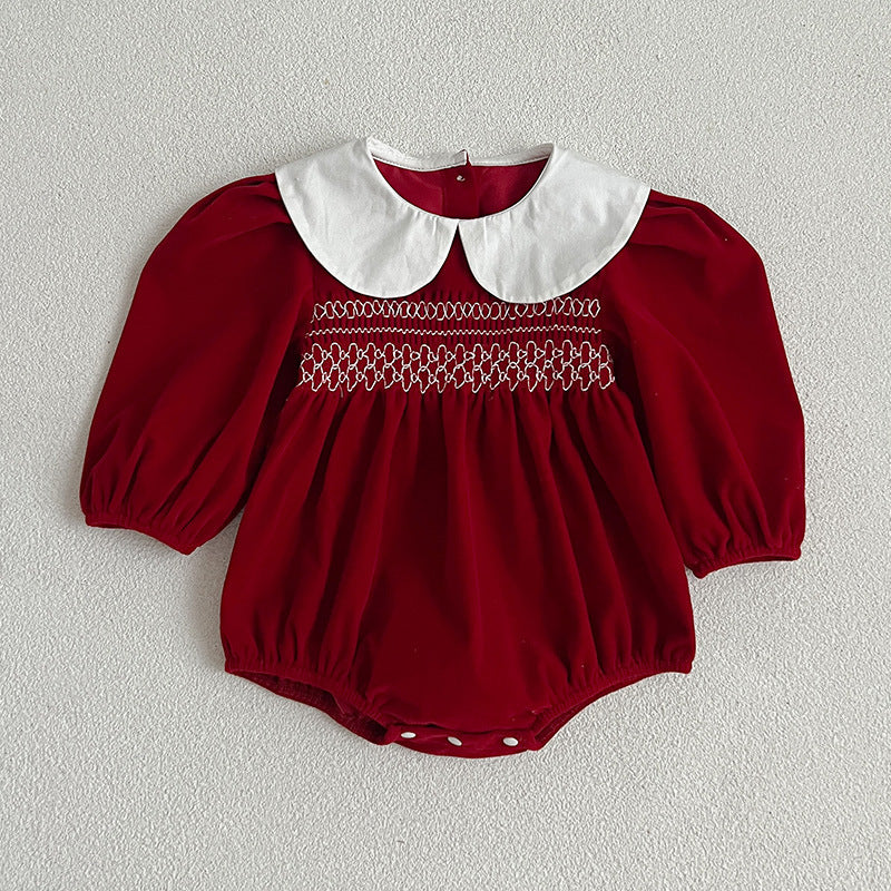 Red smocked baby romper with white Peter Pan collar