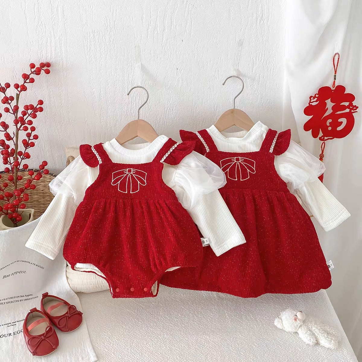 Red sparkle romper and dress with white shirts on hangers