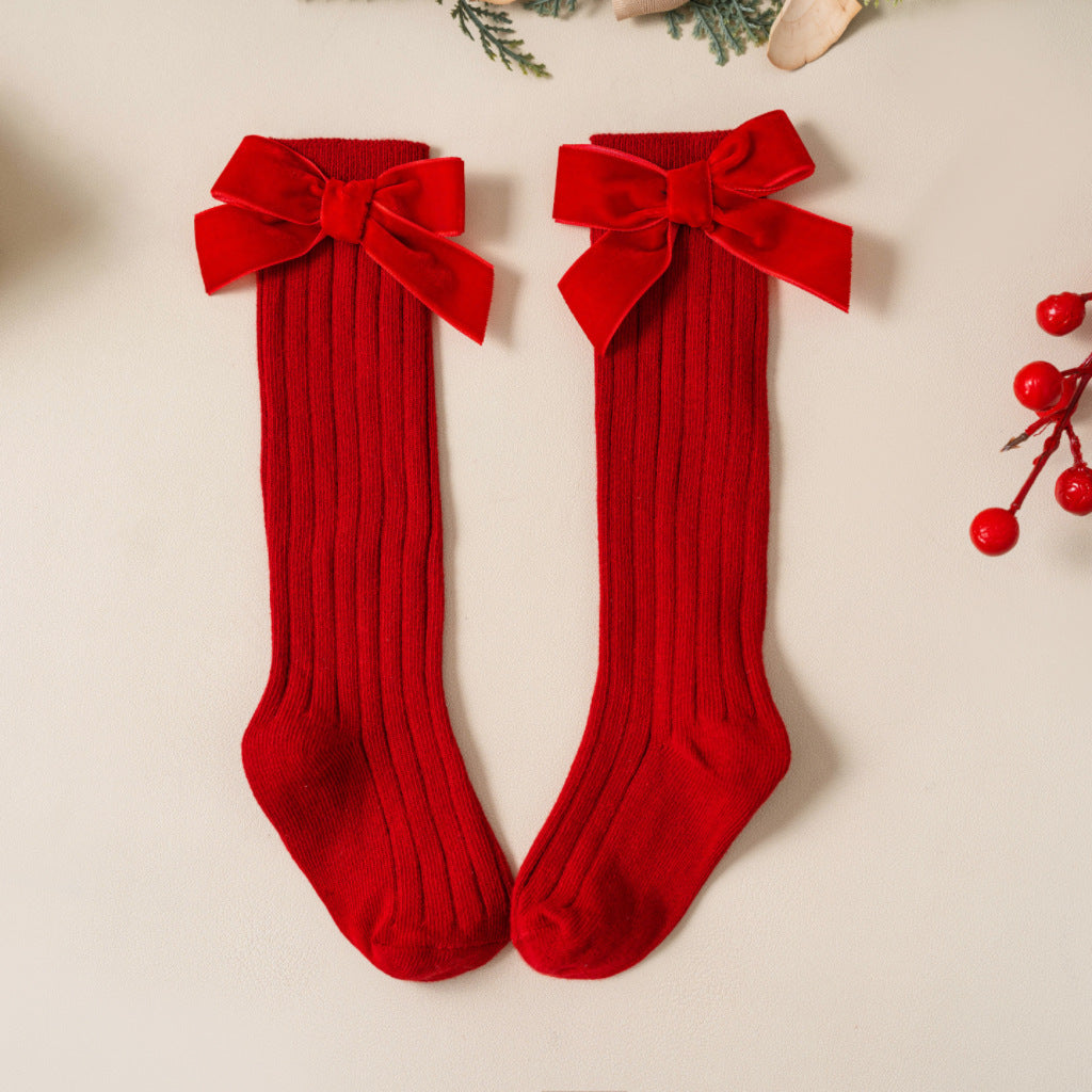 Red ribbed knee-high socks with velvet bows