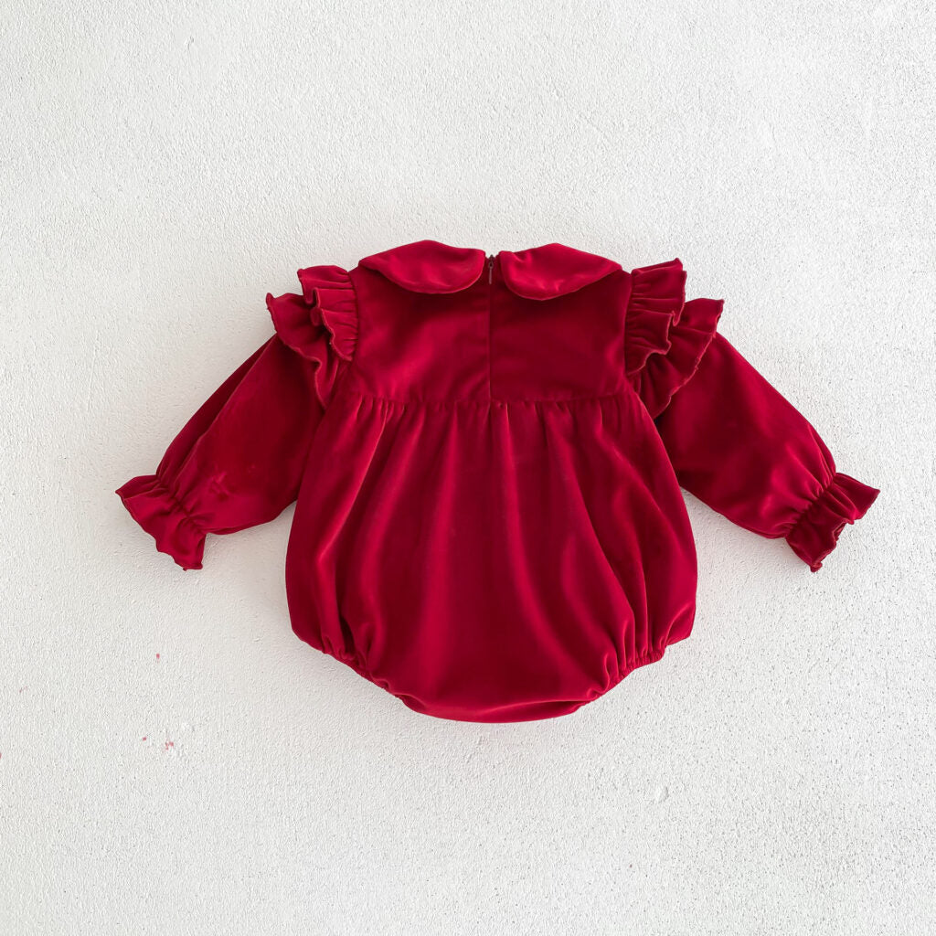 Back of red velvet romper on white background