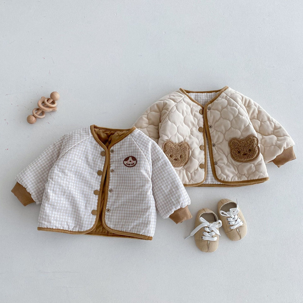 Reversible baby coats worn inside out showing the plain quilted side