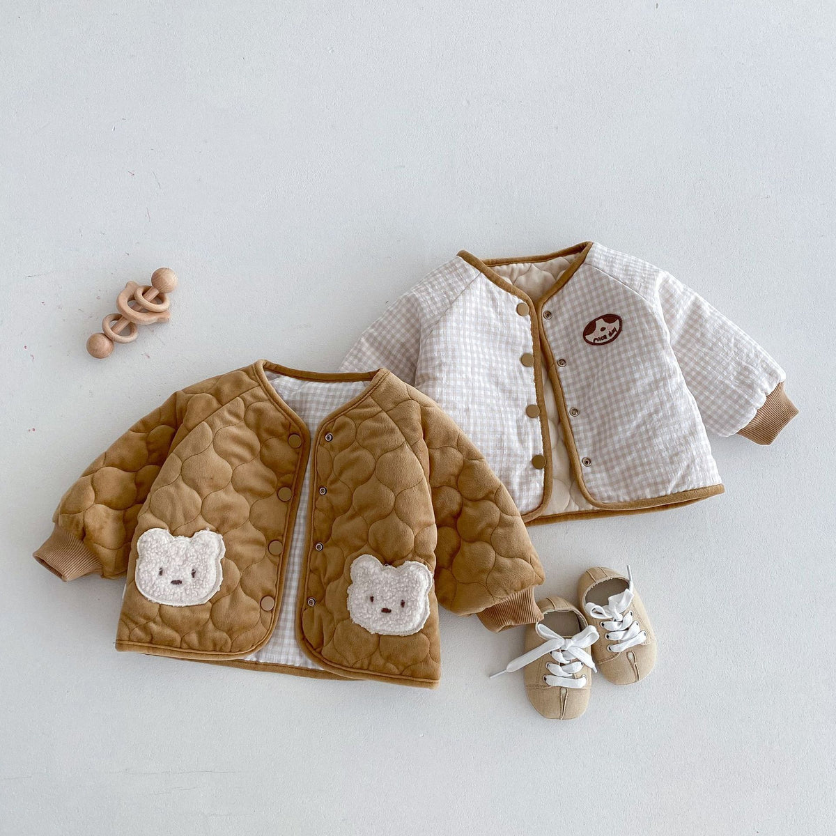 Reversible baby jackets showing bear pocket side and plain side