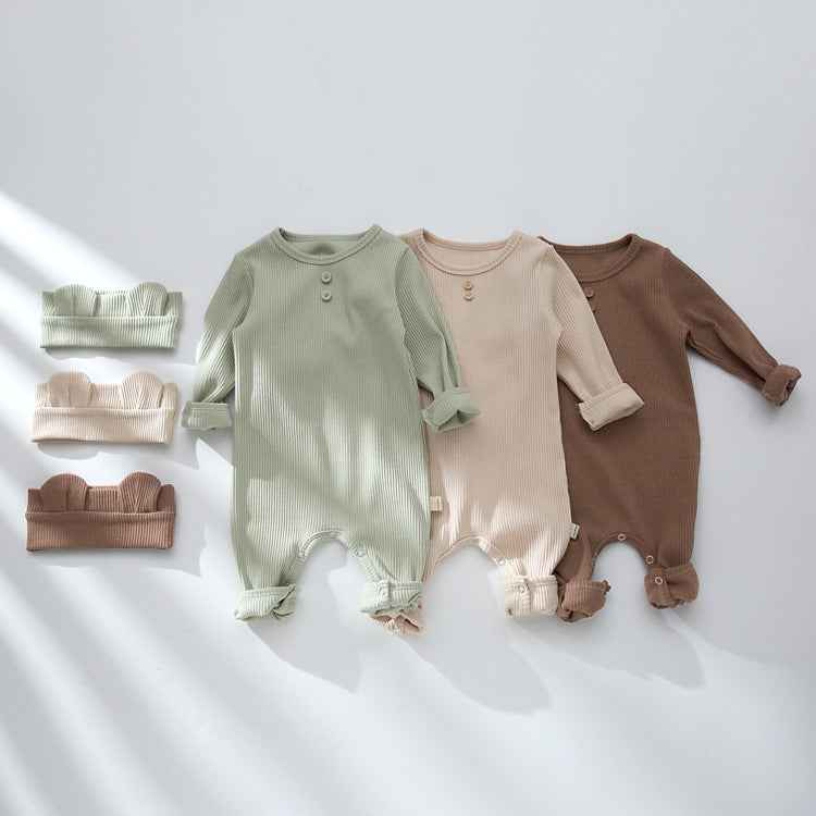 Three ribbed baby jumpsuits and headbands laid flat