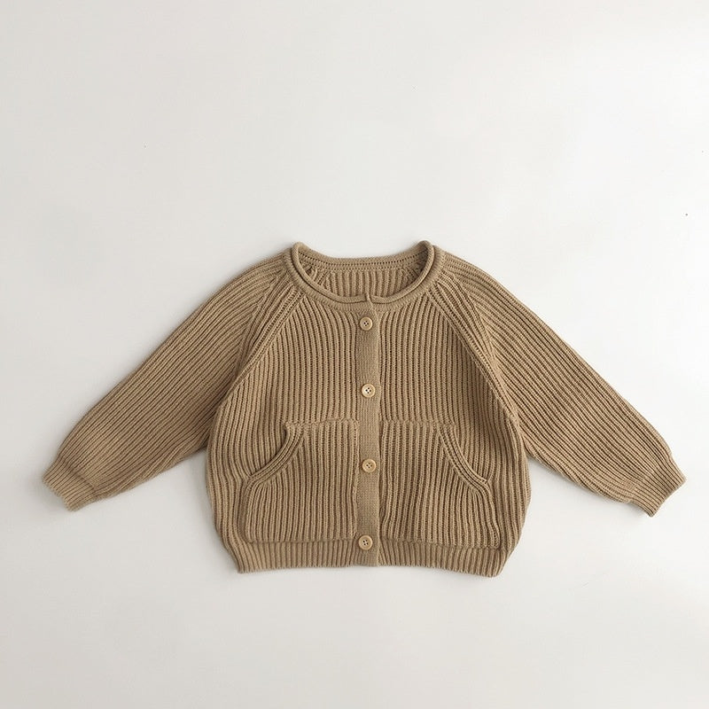 Light brown ribbed knit toddler cardigan with front pockets and wooden buttons