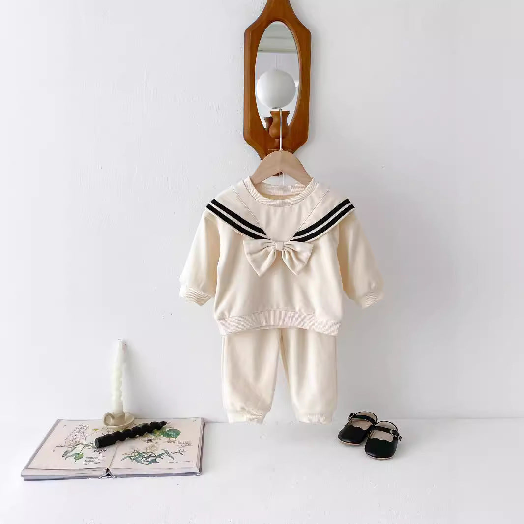 Cream sailor collar bow sweatshirt set on a hanger