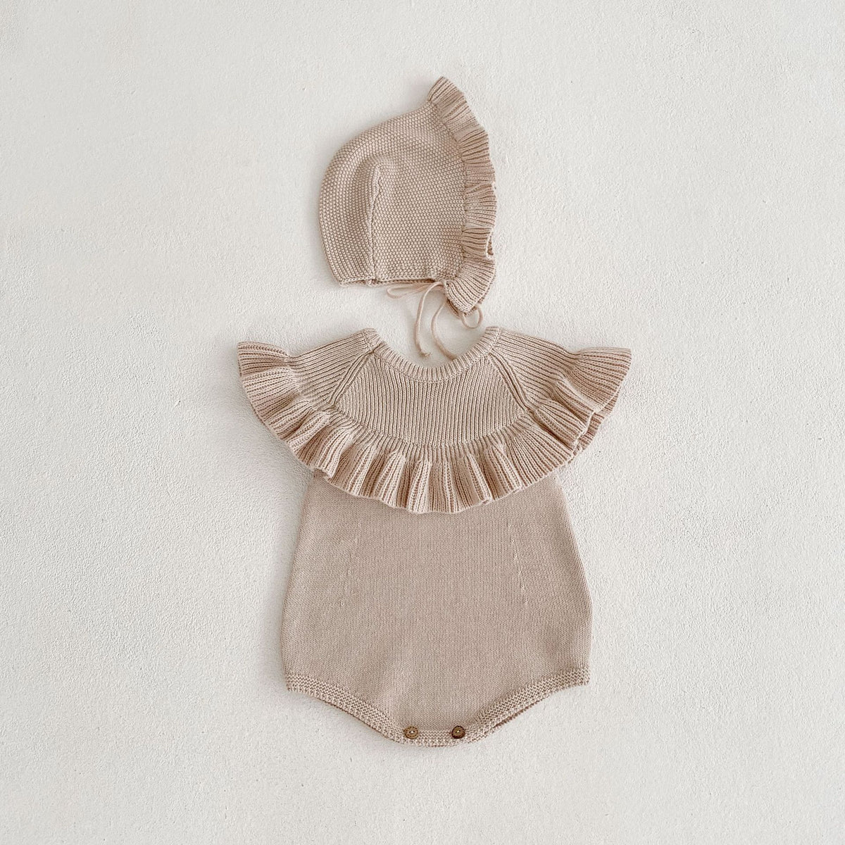 Sleeveless oatmeal knit romper with matching ruffle bonnet