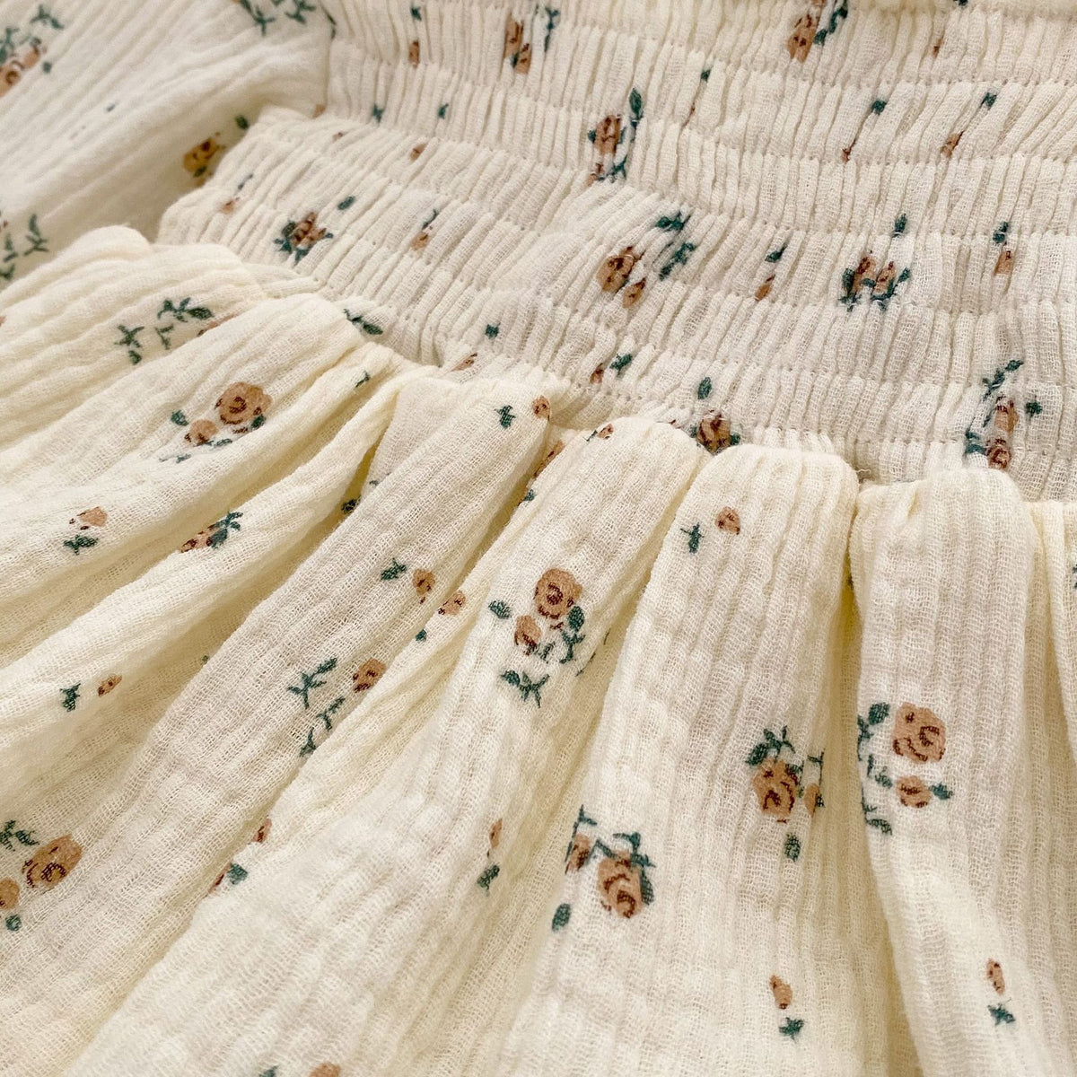 Close-up of smocked floral muslin fabric