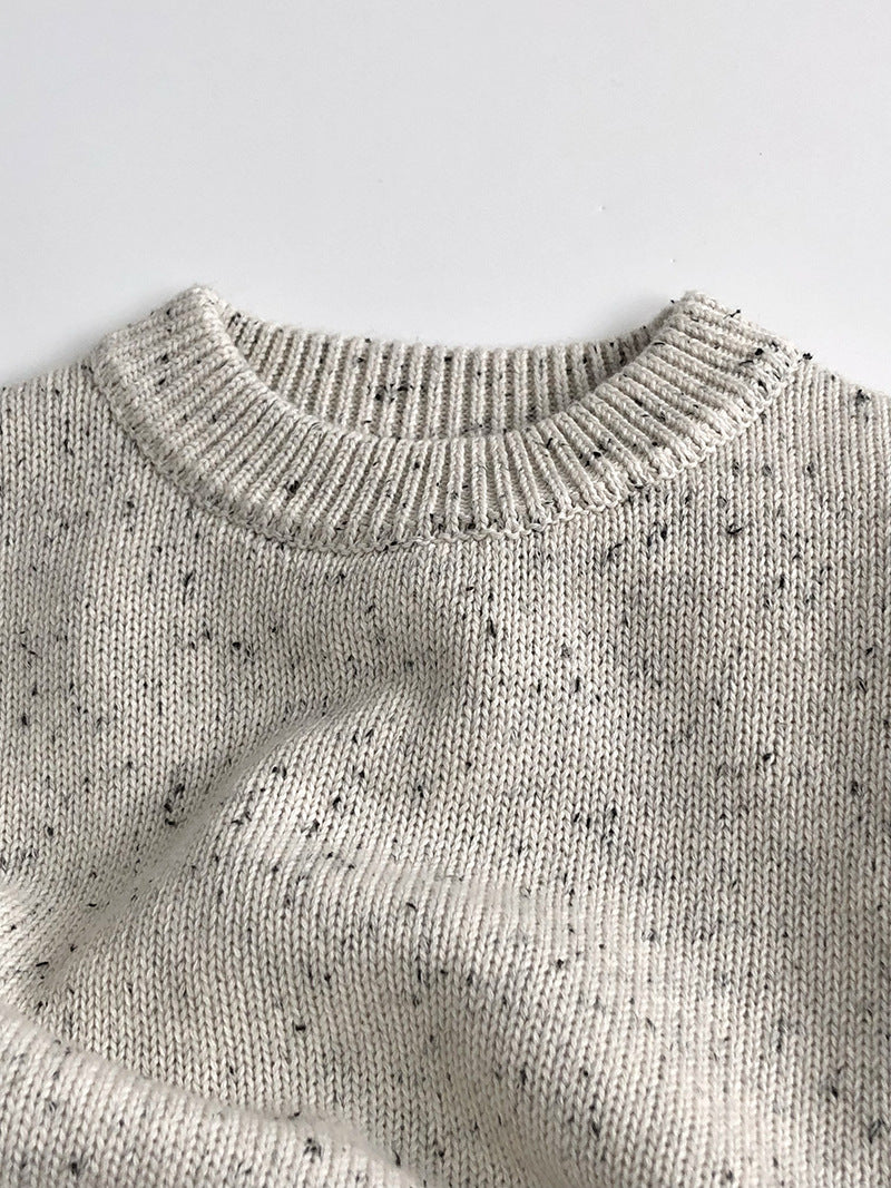 Close-up of speckled knit texture and crew neck