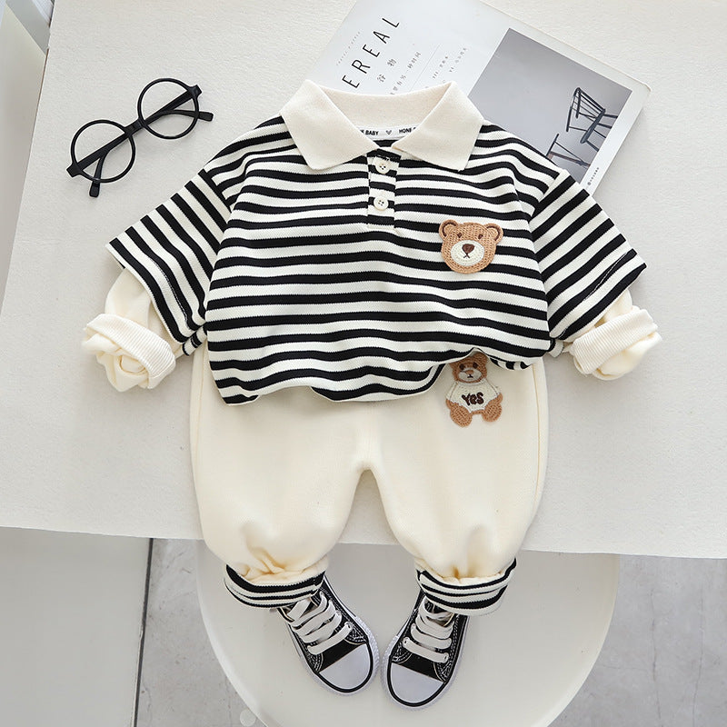 Navy striped polo sweatshirt with bear patch and cream trousers