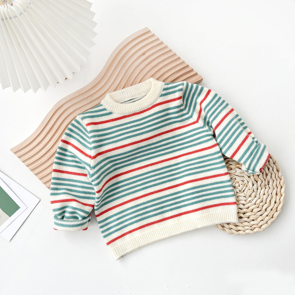 Striped knit baby jumper laid flat