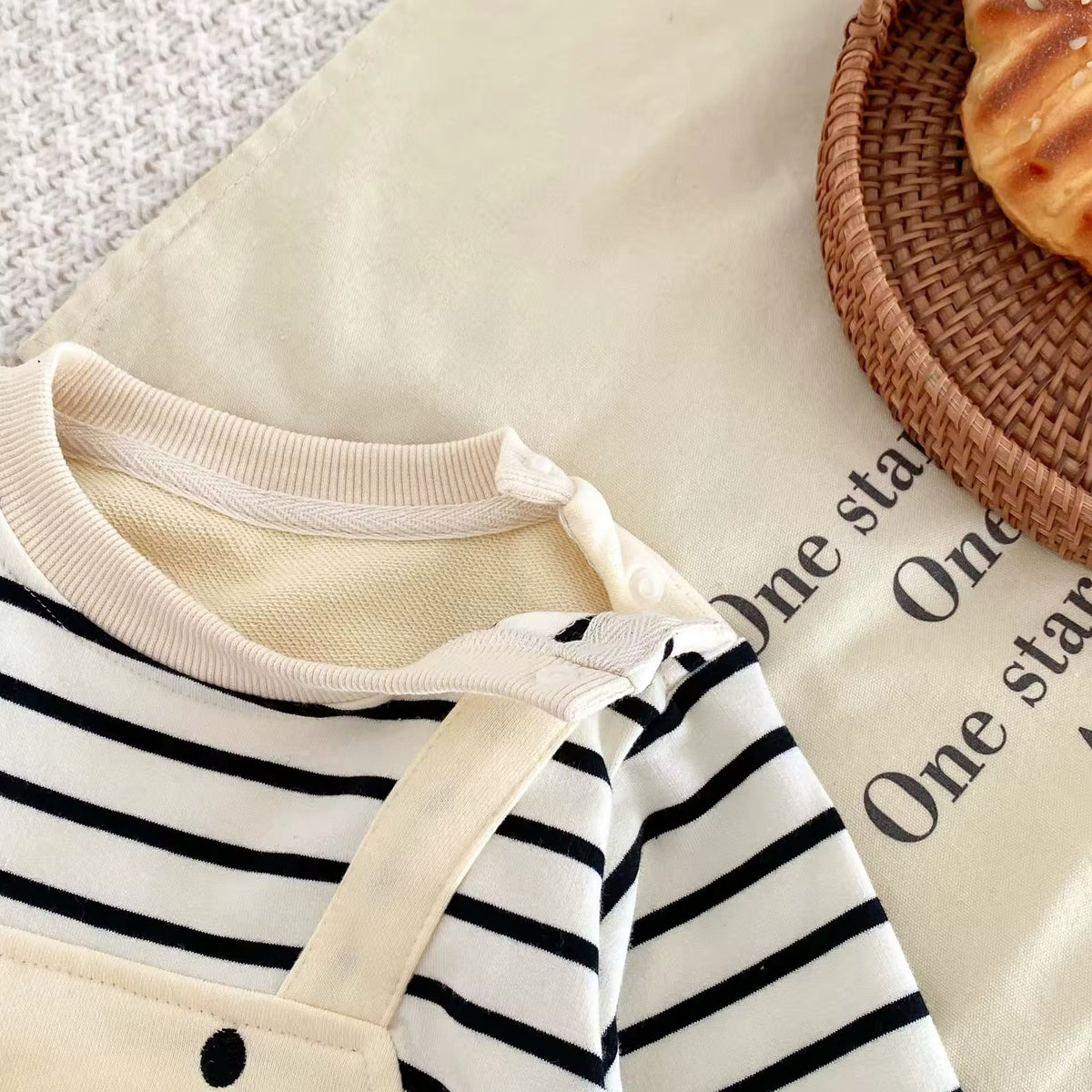 Close-up of neckline and stripes on duck romper