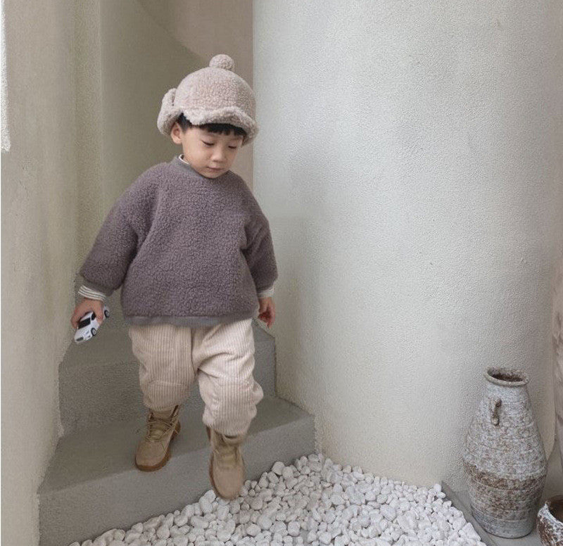 Toddler in beige carrot pants and knit sweater
