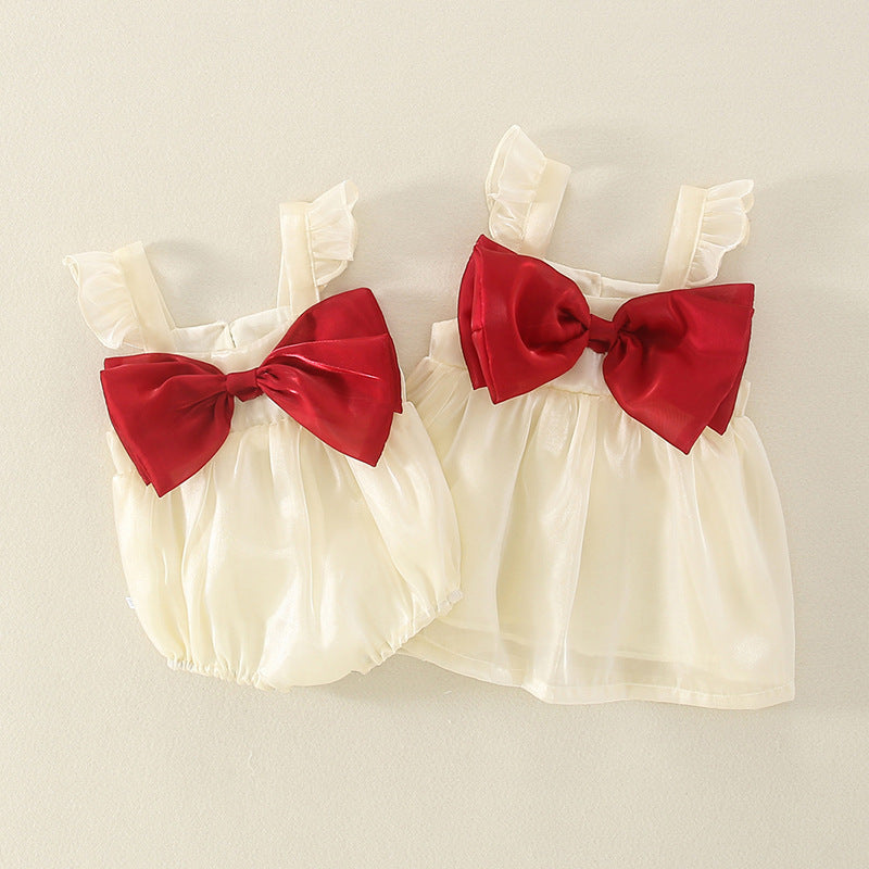 Cream tulle romper and dress with big red bows side by side