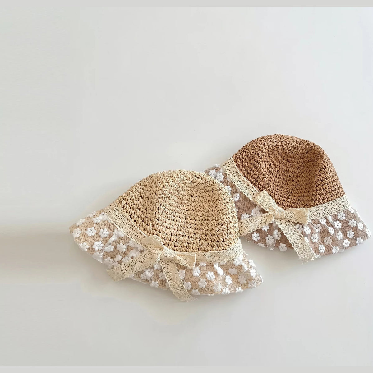 Natural and caramel lace straw hats side by side