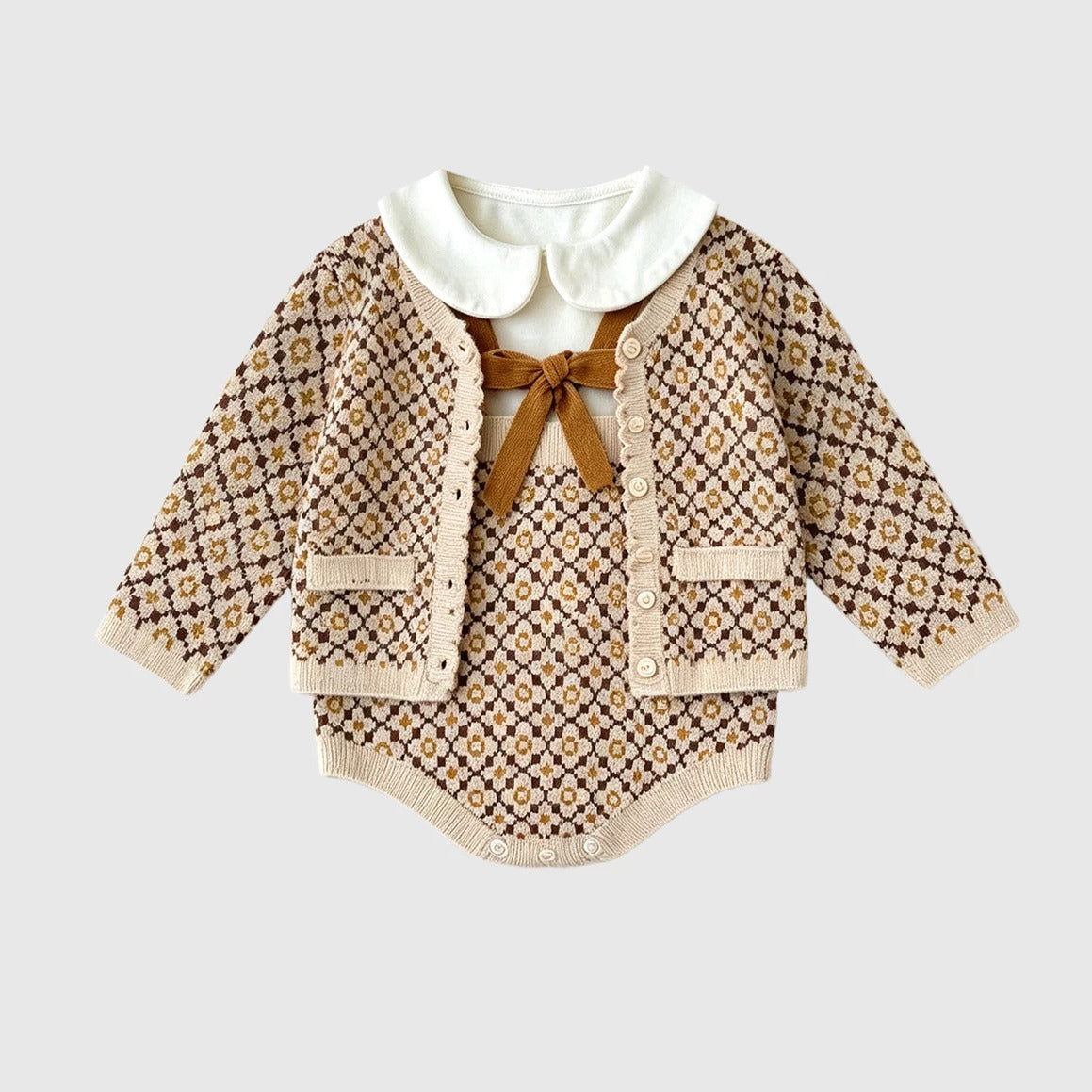 Knit cardigan over the bow romper, styled with a white collar blouse